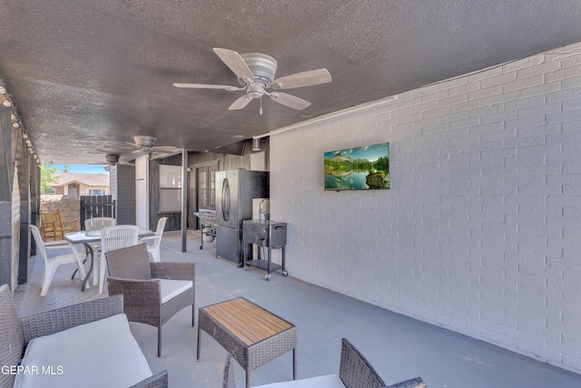 view of patio featuring an outdoor hangout area, a ceiling fan, outdoor dining space, and fence