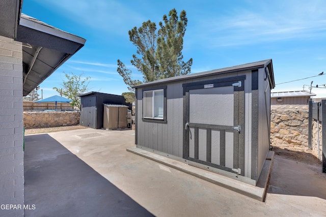view of shed featuring fence