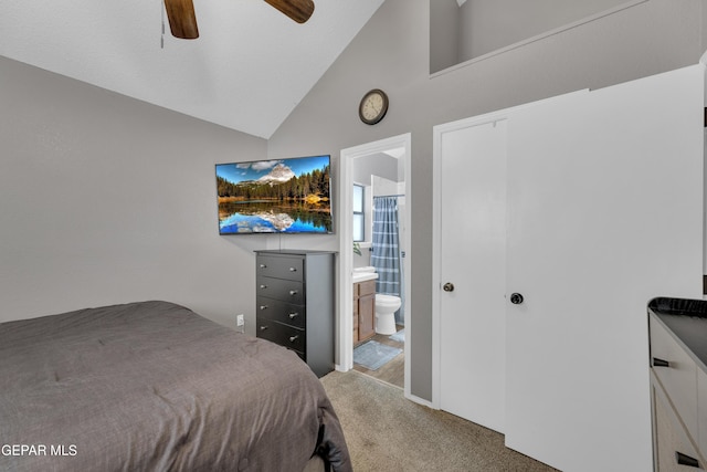 carpeted bedroom featuring connected bathroom, ceiling fan, and high vaulted ceiling