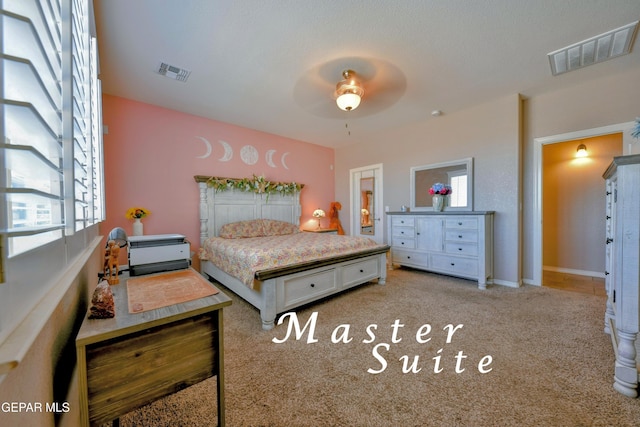 bedroom with visible vents, ceiling fan, and light carpet