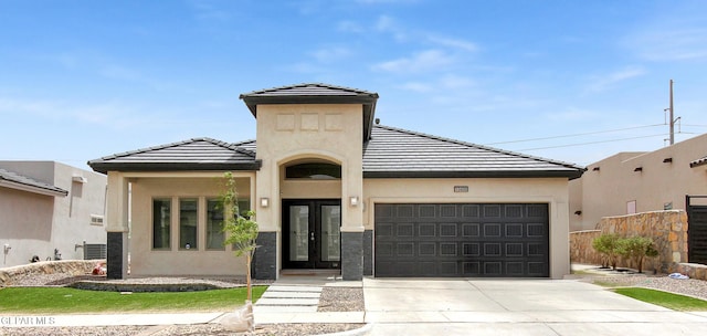 13408 Emerald Glass Dr, Horizon City, TX 79928 - view of front of home featuring french doors, an attached garage, concrete driveway, and stucco siding