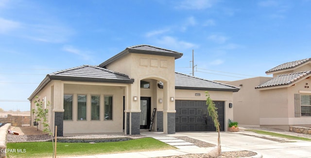 13408 Emerald Glass Dr, Horizon City, TX 79928 - view of front of house with concrete driveway, an attached garage, stucco siding, and a tile roof