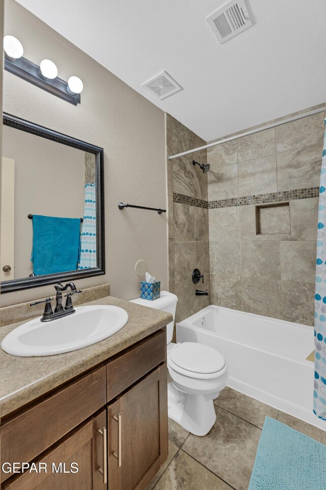 bathroom with vanity, shower / bath combo with shower curtain, toilet, and visible vents