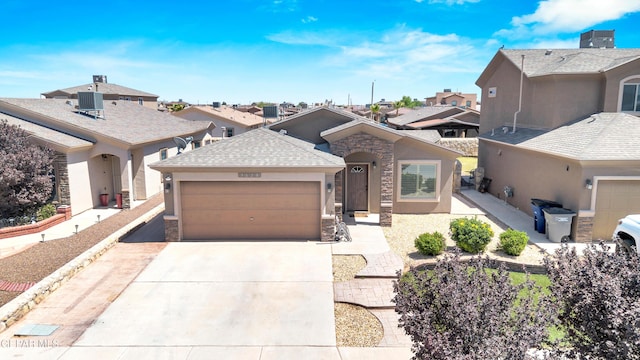 view of front of property featuring a residential view, an attached garage, concrete driveway, and stucco siding