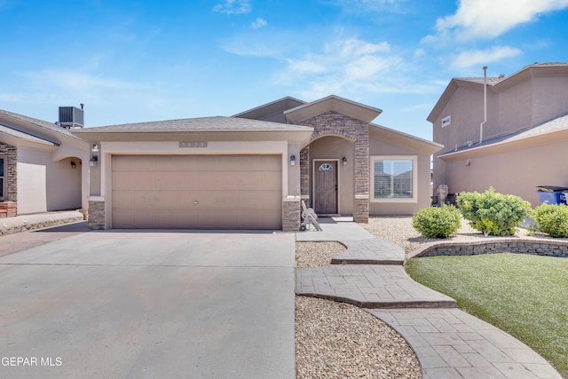 view of front of home featuring a garage, central air condition unit, concrete driveway, stone siding, and stucco siding