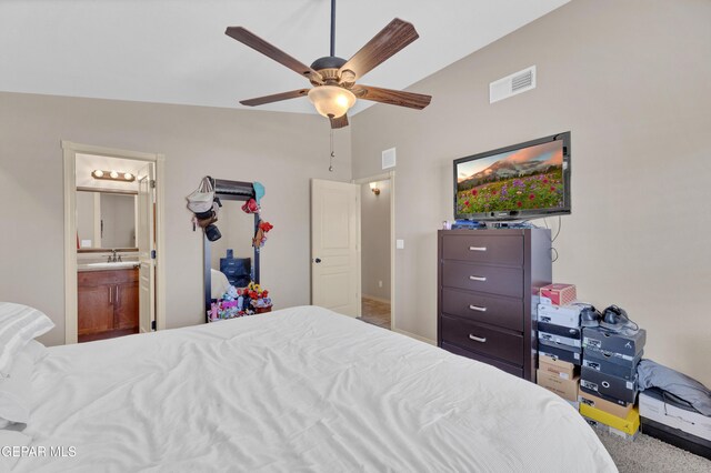 carpeted bedroom featuring high vaulted ceiling, visible vents, a sink, and ensuite bathroom