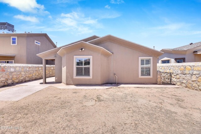 back of house featuring stucco siding, a patio area, and fence