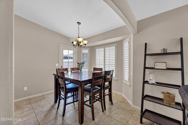 dining area featuring light tile patterned flooring, a notable chandelier, and a wealth of natural light