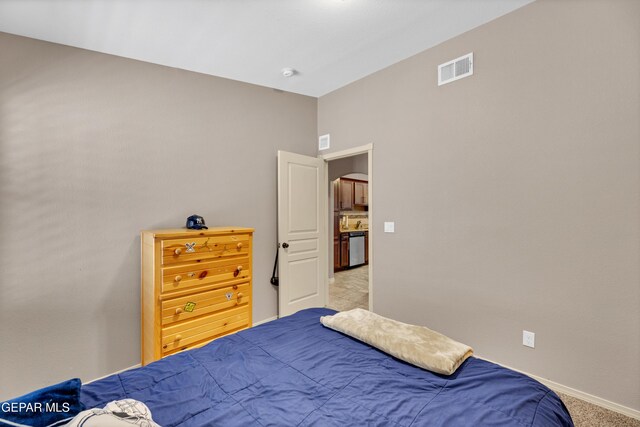 bedroom featuring baseboards, arched walkways, visible vents, and light colored carpet