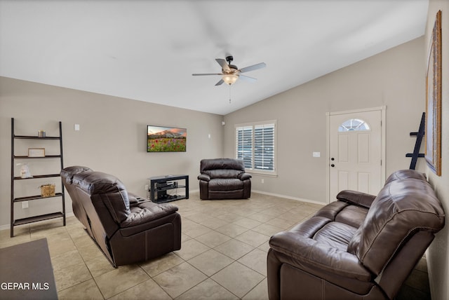 living area with baseboards, ceiling fan, light tile patterned floors, and lofted ceiling