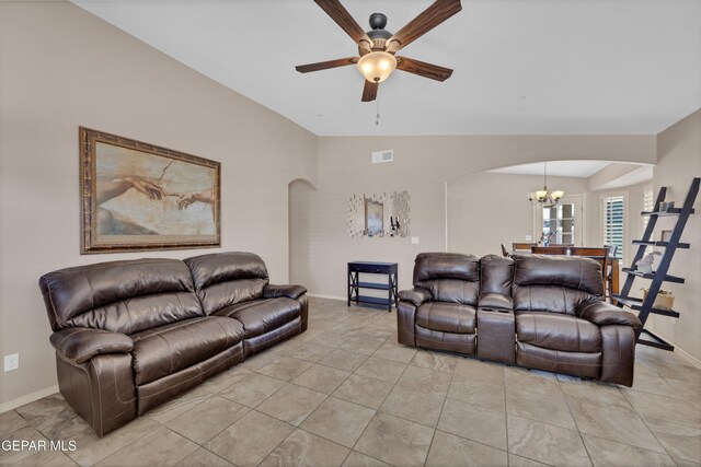 living room featuring arched walkways, baseboards, ceiling fan with notable chandelier, and visible vents