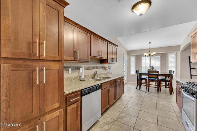 kitchen with lofted ceiling, brown cabinets, stainless steel range with gas stovetop, dishwasher, and a notable chandelier