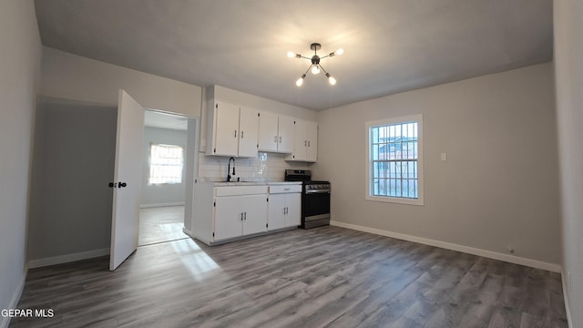 209 Hardesty Pl Unit 1 & 2, El Paso, TX 79905 - kitchen with stainless steel range with gas stovetop, a sink, and wood finished floors