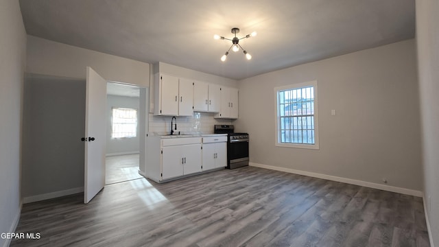 209 Hardesty Pl Unit 1 & 2, El Paso, TX 79905 - kitchen featuring stainless steel range with gas stovetop, wood finished floors, and baseboards