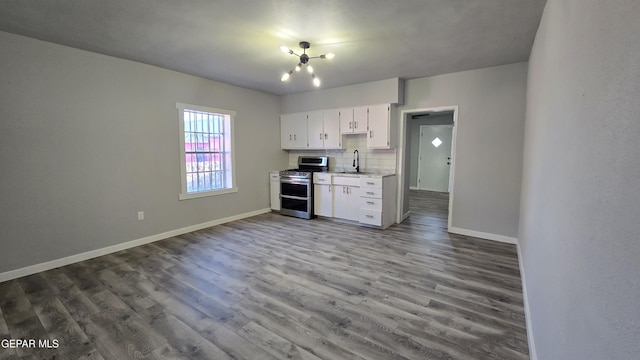 209 Hardesty Pl Unit 1 & 2, El Paso, TX 79905 - kitchen featuring double oven range, light countertops, baseboards, wood finished floors, and tasteful backsplash