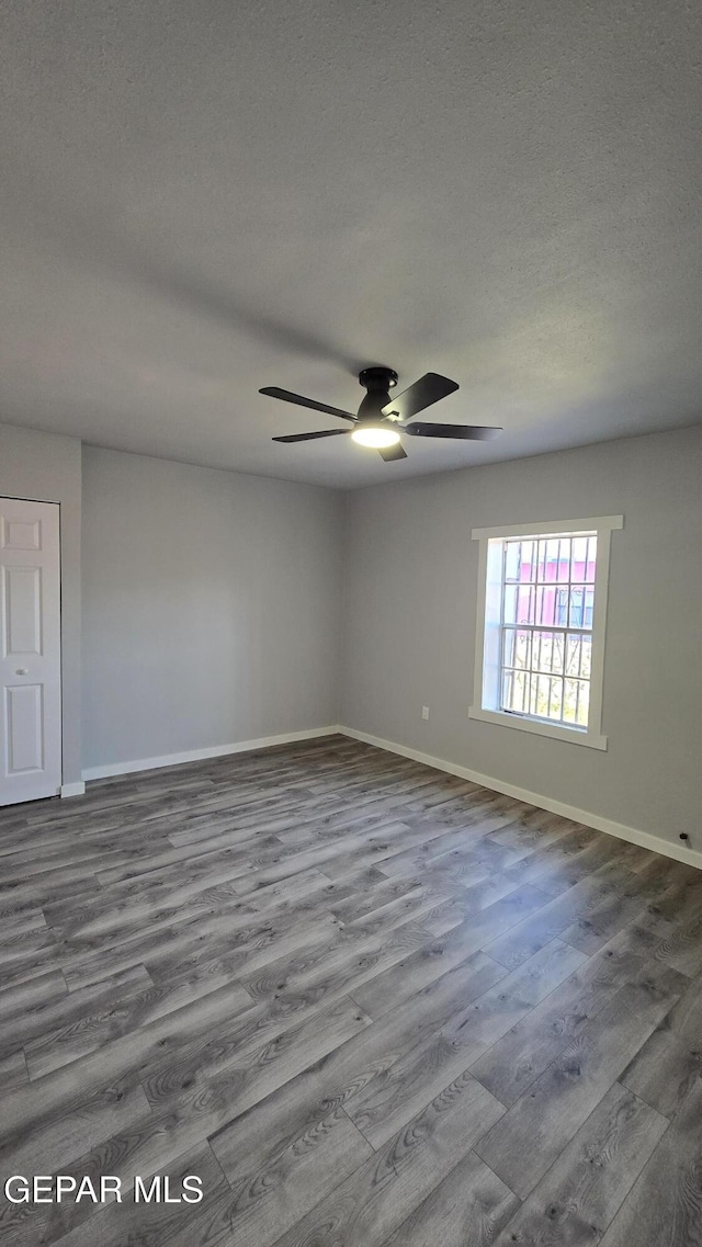 209 Hardesty Pl Unit 1 & 2, El Paso, TX 79905 - spare room with wood finished floors, a ceiling fan, baseboards, and a textured ceiling
