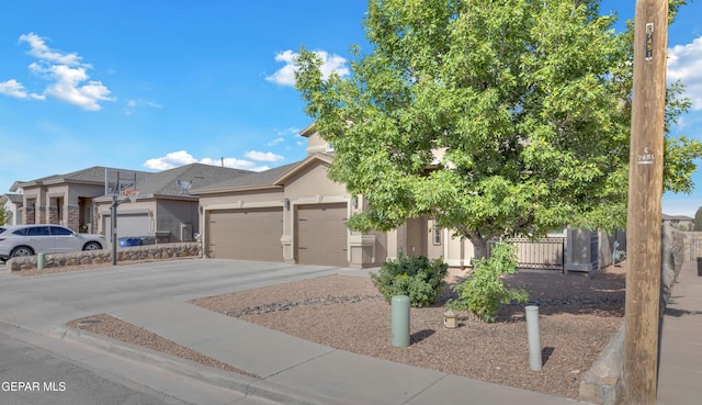 view of front of home with a garage, stucco siding, and concrete driveway