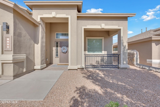 view of exterior entry with stucco siding