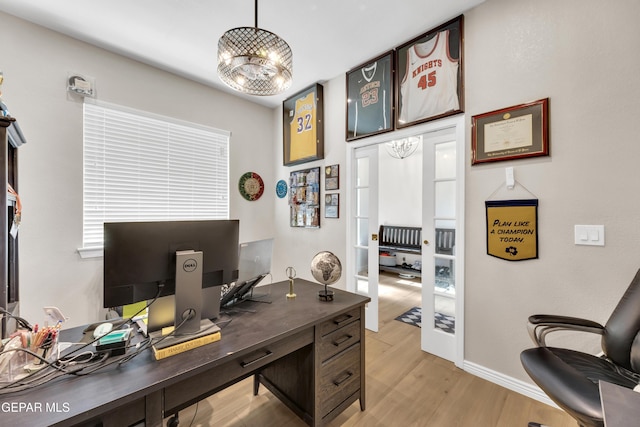 home office with baseboards and light wood finished floors