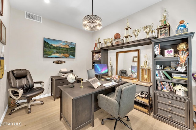 office with baseboards, visible vents, and light wood-style floors
