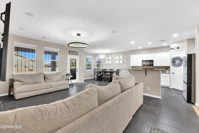 living room with recessed lighting, baseboards, and visible vents