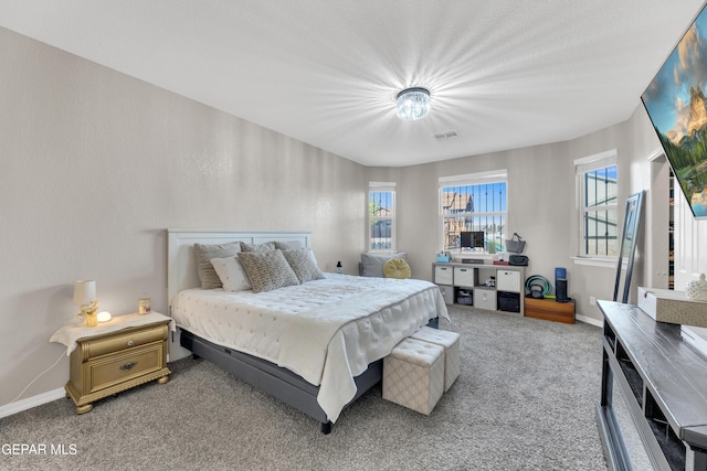 bedroom featuring light colored carpet, baseboards, and multiple windows