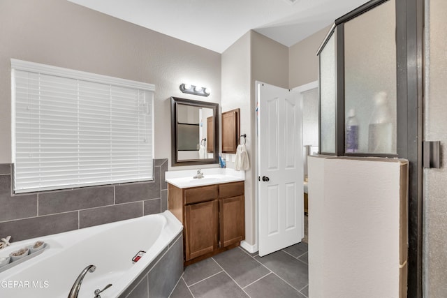 full bath featuring vanity, a garden tub, and tile patterned floors