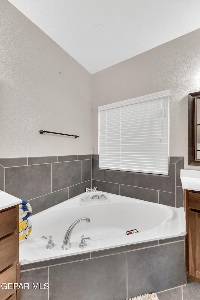 bathroom with vanity and a bath