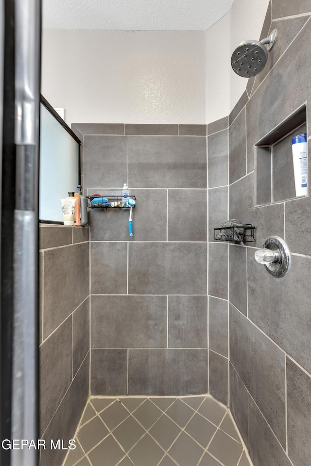 bathroom with tiled shower