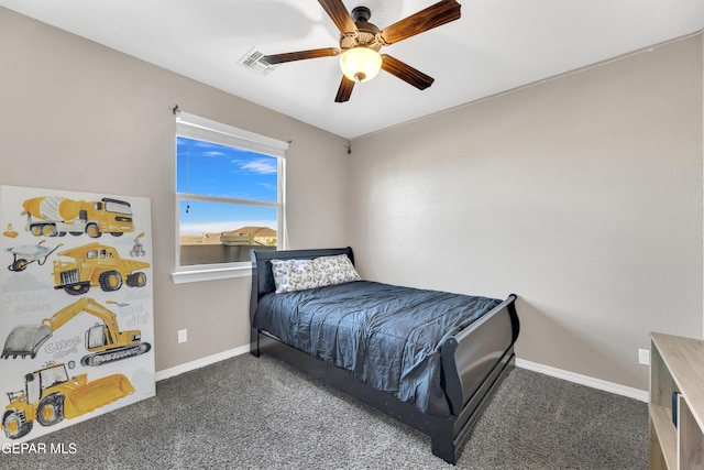 carpeted bedroom featuring baseboards and ceiling fan