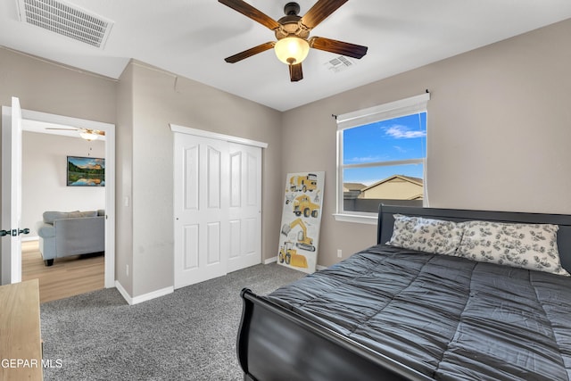 bedroom with visible vents, carpet, ceiling fan, and a closet