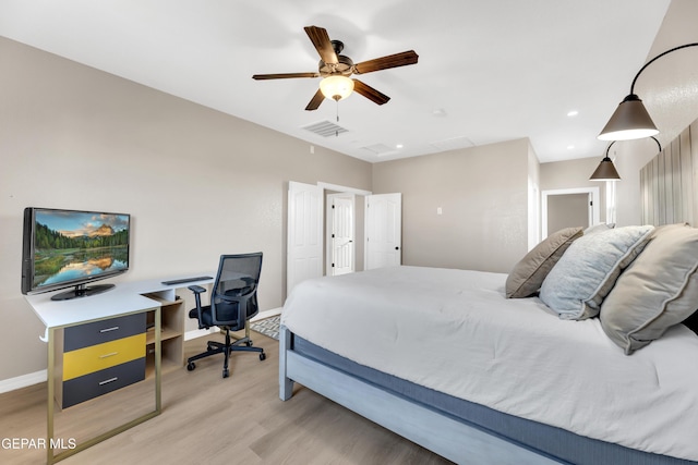 bedroom featuring baseboards, visible vents, ceiling fan, and light wood-style floors