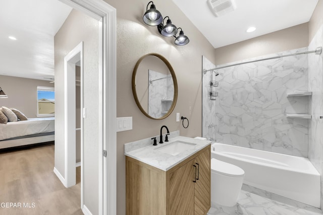 ensuite bathroom with connected bathroom, vanity, bathtub / shower combination, toilet, and recessed lighting