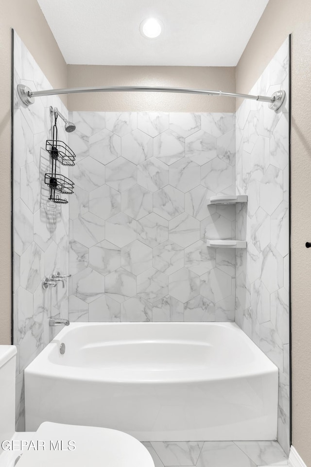 bathroom featuring recessed lighting, marble finish floor, shower / bathing tub combination, and toilet