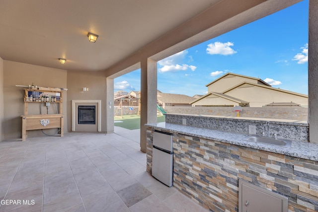 view of patio / terrace with a sink and a fenced backyard