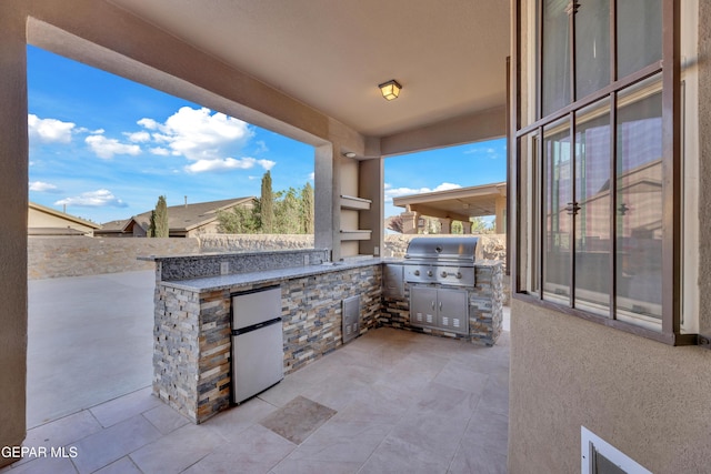 view of patio / terrace with grilling area, an outdoor kitchen, and an outdoor bar