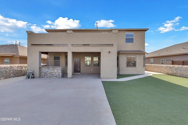 back of house with fence, stucco siding, and a patio area