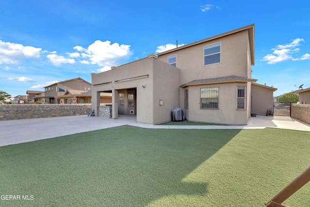back of house with a patio, fence, and stucco siding