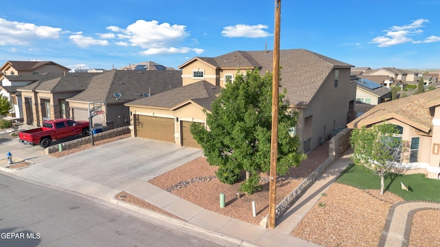 view of front facade with a residential view, stucco siding, driveway, and a garage