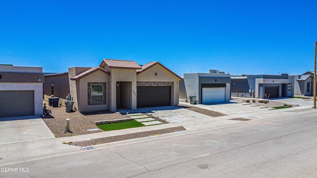 14940 Tierra Escape Ave, El Paso, TX 79938 - view of front of house featuring a tiled roof, an attached garage, driveway, and stucco siding