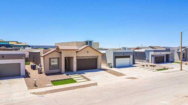 14940 Tierra Escape Ave, El Paso, TX 79938 - view of front of house featuring stucco siding, a residential view, an attached garage, driveway, and a tile roof