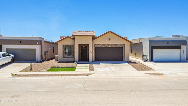 14940 Tierra Escape Ave, El Paso, TX 79938 - view of front of house featuring concrete driveway, an attached garage, a tile roof, and stucco siding