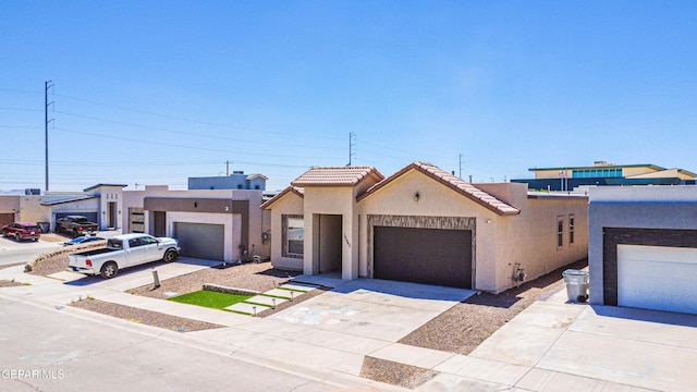 14940 Tierra Escape Ave, El Paso, TX 79938 - view of front of house with an attached garage, driveway, a tile roof, and stucco siding