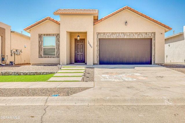14940 Tierra Escape Ave, El Paso, TX 79938 - view of front of home featuring an attached garage, stucco siding, a tiled roof, and concrete driveway