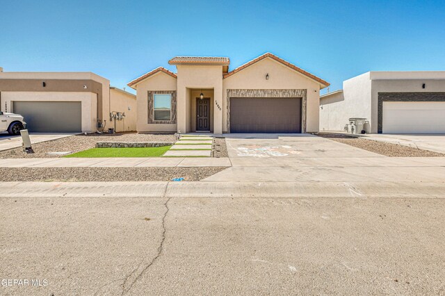 14940 Tierra Escape Ave, El Paso, TX 79938 - view of front of home with a tiled roof, a garage, stucco siding, and driveway