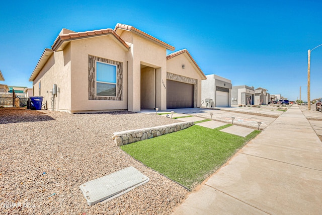 14940 Tierra Escape Ave, El Paso, TX 79938 - view of front of property featuring a tiled roof, an attached garage, driveway, and stucco siding