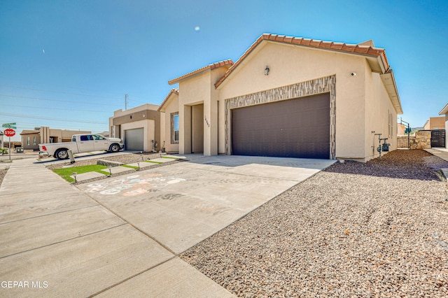 14940 Tierra Escape Ave, El Paso, TX 79938 - mediterranean / spanish-style home with concrete driveway, a garage, a tile roof, and stucco siding