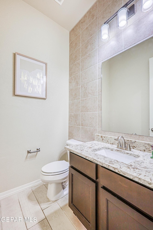 14940 Tierra Escape Ave, El Paso, TX 79938 - bathroom with tile patterned flooring, vanity, toilet, baseboards, and tile walls