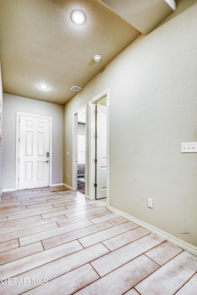 14940 Tierra Escape Ave, El Paso, TX 79938 - foyer entrance with visible vents, light wood-style flooring, a textured ceiling, and baseboards