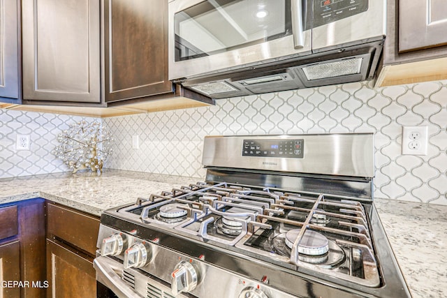 14940 Tierra Escape Ave, El Paso, TX 79938 - kitchen featuring decorative backsplash, dark brown cabinetry, stainless steel appliances, and light stone countertops